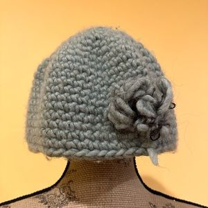 Hand made soft turquoise knitted hat with flower on the side